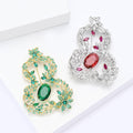 Openwork Gourd Brooch In Metal With Colored Crystals, An Oval Center Stone, And A Bow Top view 4