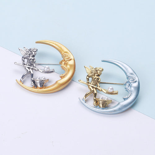 The first image shows the crescent moon and fairy brooch from the front.