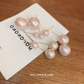 Pink Pearl Stud Earrings with Gold Tone Posts with Polished Metal Accents view 3