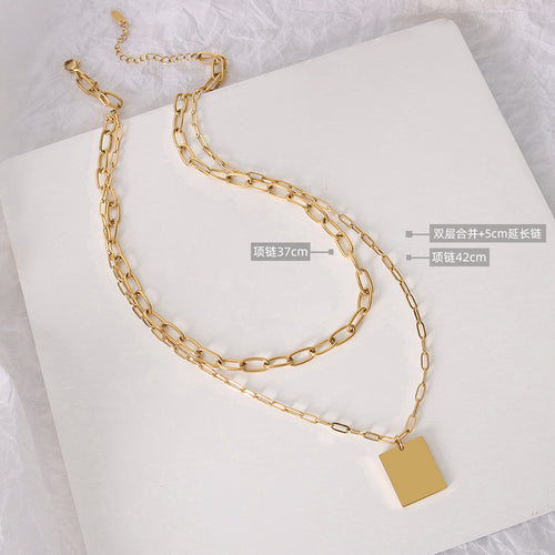 Gold layered paperclip necklace flat lay with length callouts