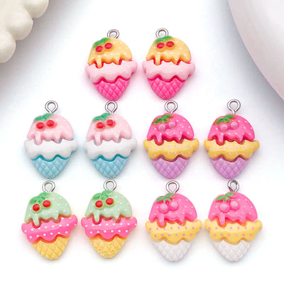 Multicolor cherry and ice cream charms arranged on a light background