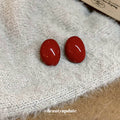 Glossy Red Oval Stud Earrings With Smooth Domed Finish view 3