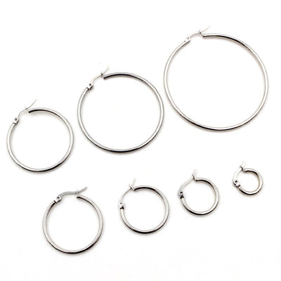 Overview of seven sizes of thin silver-tone hinged hoop earring findings on a light background