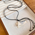 Silver Tone Triangle Pendant Necklace on Double Black Cord view 1