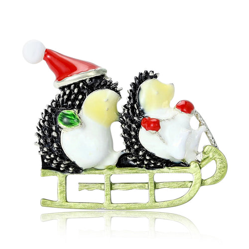 Angled display of two hedgehogs in a green sleigh, one wearing a red Santa hat