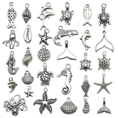 Metallic starfish and turtle charms arranged on a light background