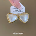 Pearl-Like Heart Stud Earrings with Gold Trim with Polished Metal Details view 2