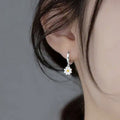 Silver Tone White Yellow Daisy Charm Huggie Hoop Earrings view 3