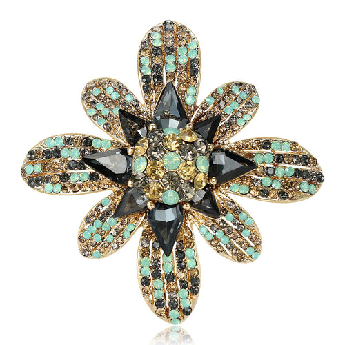 Gold tone eight petal crystal flower brooch dark gray center stones