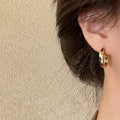Irregular Sculpted Metal Hoop Earrings in Gold and Silver view 3