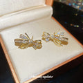 Gold Tone Crystal Bow Tassel Stud Earrings With Polished Metal Details view 3