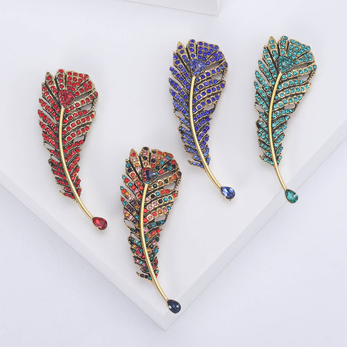 Four rhinestone feather brooches in red multicolor blue and teal