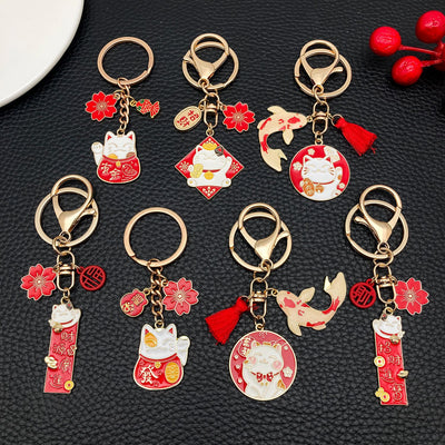 Overview showing the available color and design variations of the red lucky cat koi and fortune metal keychain