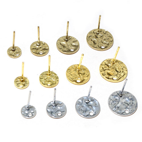 Overview of round textured discs, straight posts, and hanging holes in gold and silver tones