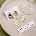White Cat Floral Enamel Stud Earrings Gold Outline Daisy Leaves view 1