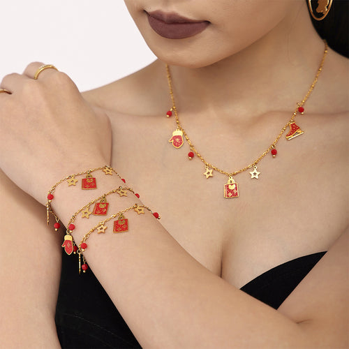 Model wears gold Christmas gift bag and mitten charm necklace with layered charm bracelets
