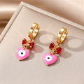 Gold Tone Bow and Heart Evil Eye Huggie Drop Earrings view 6