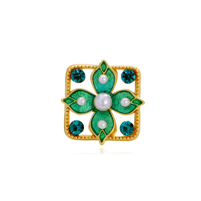 Front product view of an emerald green enamel flower brooch