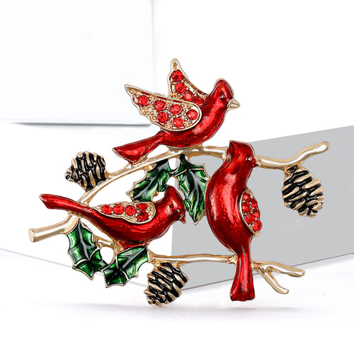Angled view of the three red birds on branch brooch