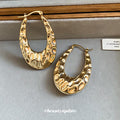 Textured Open Oval Huggie Earrings with Polished Metal Tone Details view 3