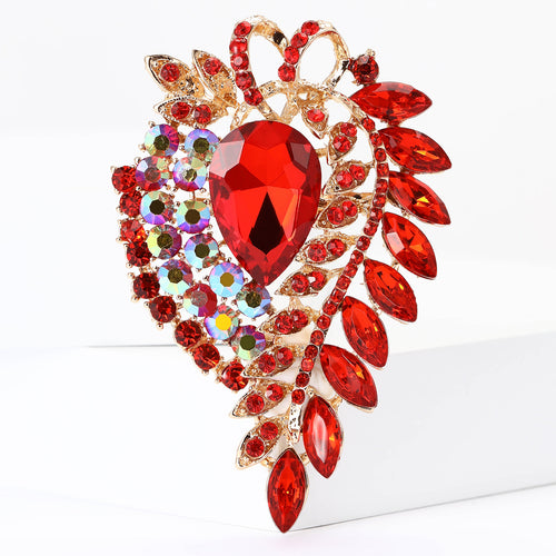A large teardrop center framed by layered marquise crystals shown in a styled display.