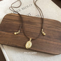 Textured Oval Pendant Necklace On Brown Cord Jewelry Design view 4