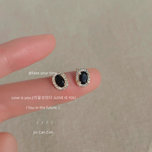 Gold-tone black-oval clear-halo mini studs in the first product display.