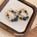 Blue and Brown Beaded Hoop Drop Earrings with Metal Tone Details view 1