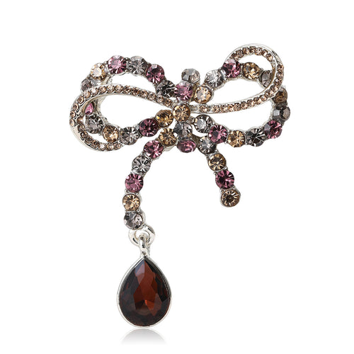 Front view showing the crystal ribbon bow brooch with large faceted teardrop dangle