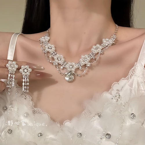 Silver pearl flower teardrop necklace worn with fringe earrings