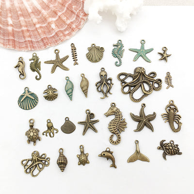 Yellow starfish and seahorse charms arranged on a light background