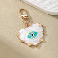 Gold Tone White Heart and Round Evil Eye Clip Keychains view 3