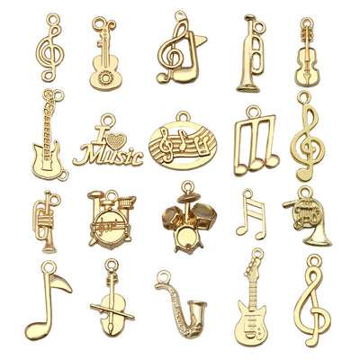 Yellow guitar and musical instrument charms arranged on a light background