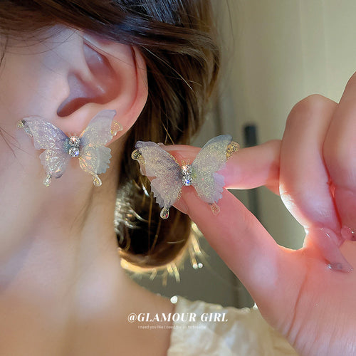 Pastel Iridescent Butterfly Stud Earrings Polished Metal Jewelry modeled at the ear