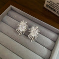 Silver Tone Crystal Firework Burst Stud Earrings With Decorative Metal Accents view 6