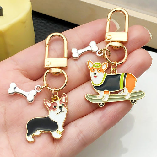 Grouped sixteen sporty dog and bone enamel keychains arranged together on a styled display surface