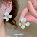 White Flower Stud Earrings with Gold Tone Centers with Decorative Details view 1