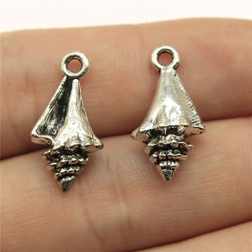 Antique Silver textured conch shell charm front view on fingertips