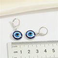 Silver Tone Round Glass Blue Evil Eye Huggie Drop Earrings view 2
