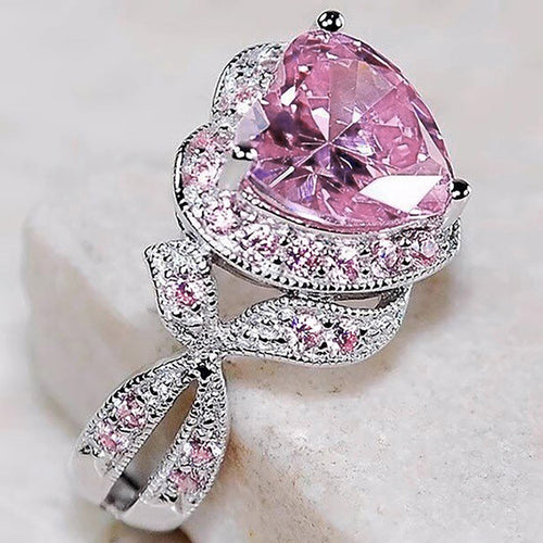 Product view showing pink heart solitaire looping leaf ring in silver tone