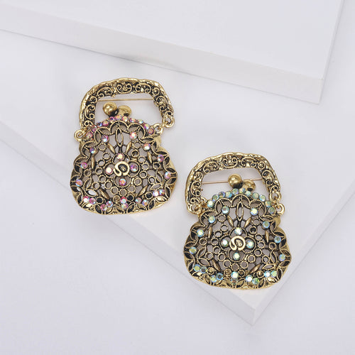 Front view of openwork handbag brooch with pastel crystal accents