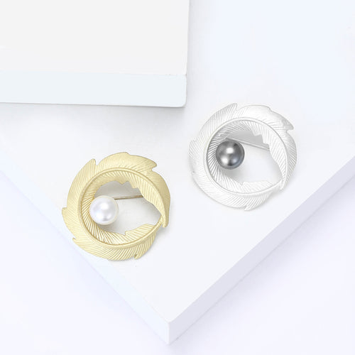 Matte gold and matte silver leaf brooches with pearls side by side