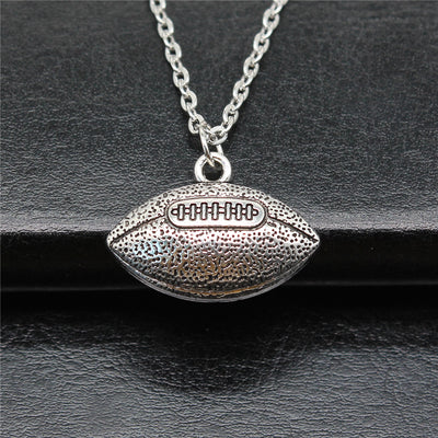 Close-up of american football pendant necklace showing a textured American football pendant on a chain