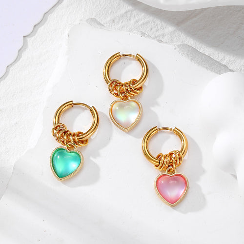 Three gold hoop heart charm earrings in green white and pink on white stone