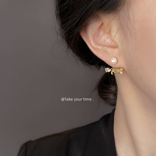 Gold pearl front with bow crystal jacket worn on ear side profile