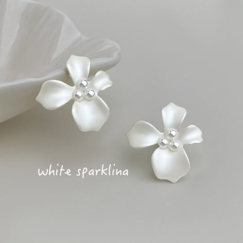 White-painted-flower high-luster-pearl studs in the first product display.