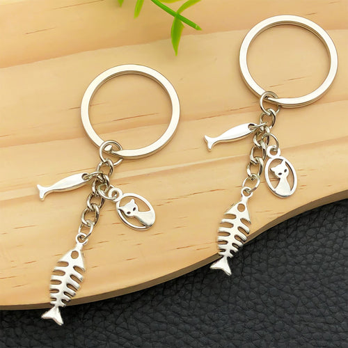 Alternate arrangement of the antique silver cat and fish bone metal keychain showing its hardware and charm details