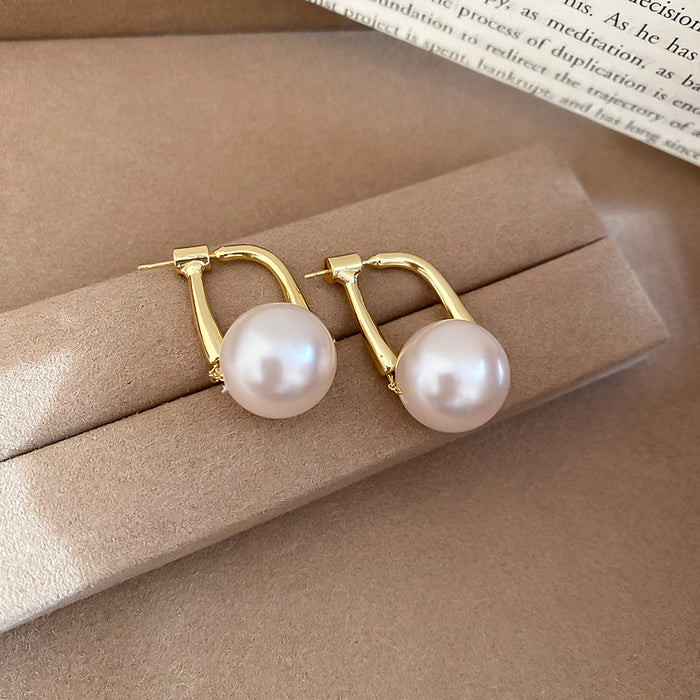 Gold Tone Curved Bar and Pearl Stud Earrings With Polished Metal Details