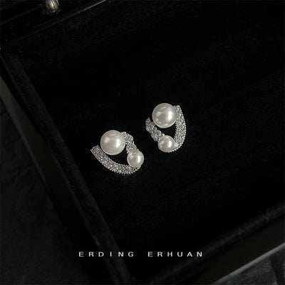 Dual pearl geometric pave studs in black jewelry box