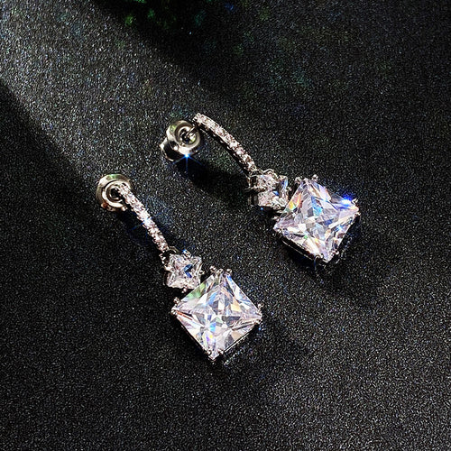 Styled view showing square clear drops beneath slim stone-set bars